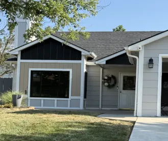 Gray house with white trim and black roof, modern suburban exterior